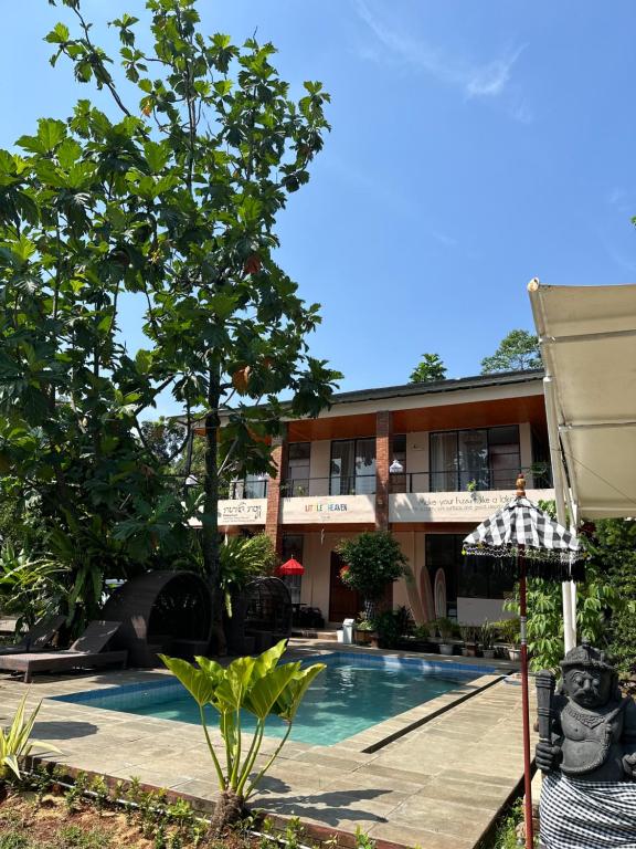 a resort with a swimming pool and a building at Little Bali Villa - Luxury Lake View at Bogor in Kalisuren 2