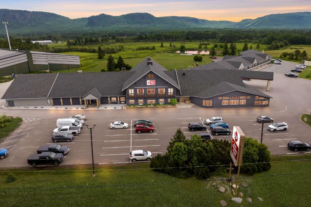a large building with cars parked in a parking lot at Best Western Plus NorWester Hotel & Conference Centre in Thunder Bay