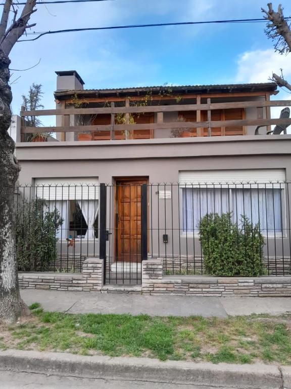 a house with a gate in front of it at La Escondida in San Antonio de Areco