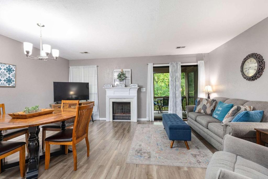 a living room with a couch and a dining room at 2 Bd 2 Bath Indoor Outdoor Pool Hot tub in Branson