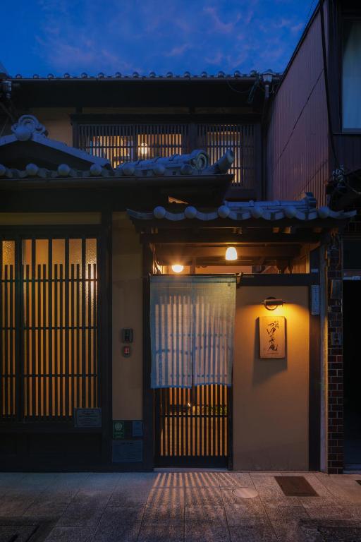 a pair of doors to a building at night at Tsuyukusa-an in Kyoto