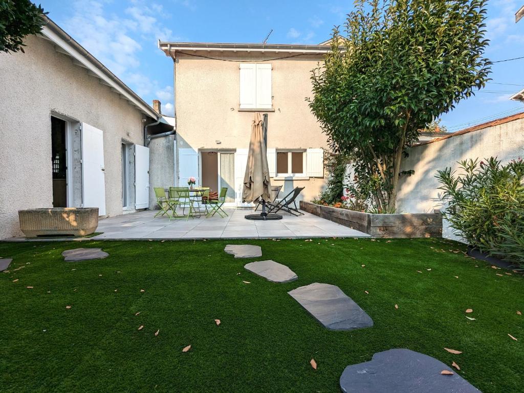 un cortile con un prato con delle rocce di Maison lumineuse au cœur d'Arcachon, plage à 200m, terrasse privée ! - FR-1-420-148 ad Arcachon