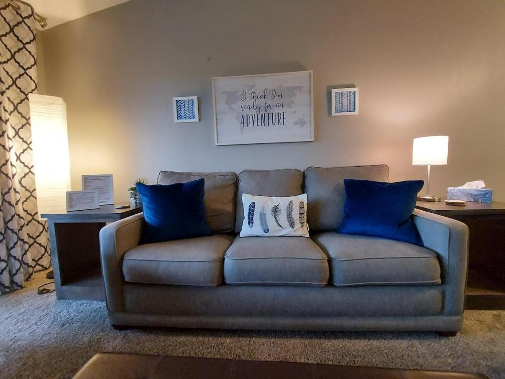 a couch with blue pillows in a living room at Placid Place Walk to Marina Fishing in Branson