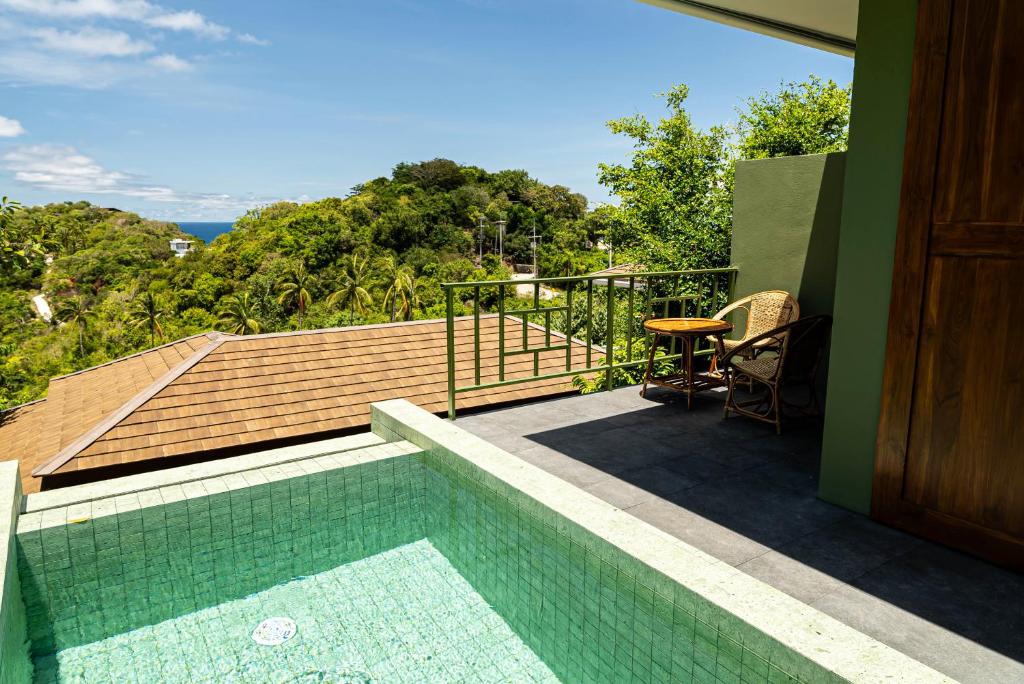 a house with a swimming pool on a balcony at Mae Ya Resort in Ko Tao