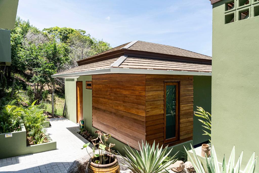 a small house with a wooden exterior at Mae Ya Resort in Ko Tao