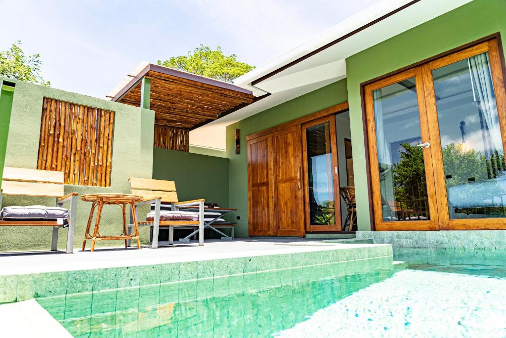 a house with a pool and a table and chairs at Mae Ya Resort in Ko Tao