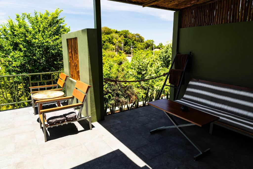 a porch with a bench and a table on a balcony at Mae Ya Resort in Ko Tao