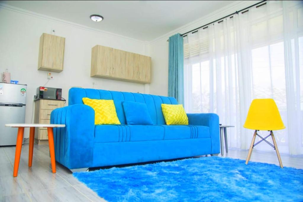 a blue couch in a living room with a blue rug at Kezmo Paradise in Mombasa