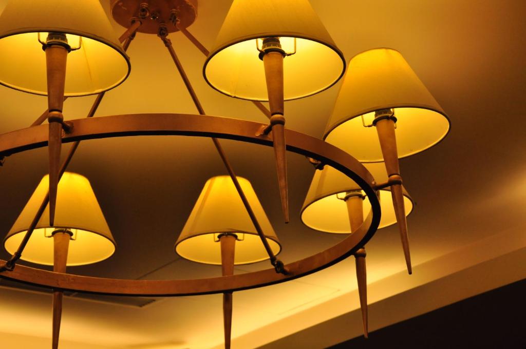 a chandelier with yellow lights on a ceiling at Jingan Classic Inn in Zhonghe