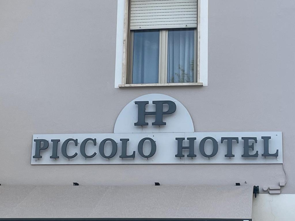 a sign for a hotel on the side of a building at Piccolo Hotel in Rosignano Solvay
