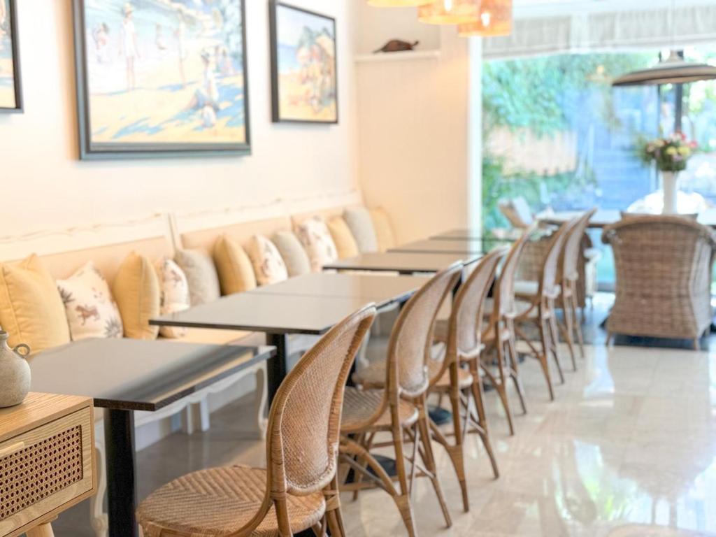 a row of tables and chairs in a restaurant at Hôtel de Provence in Cannes