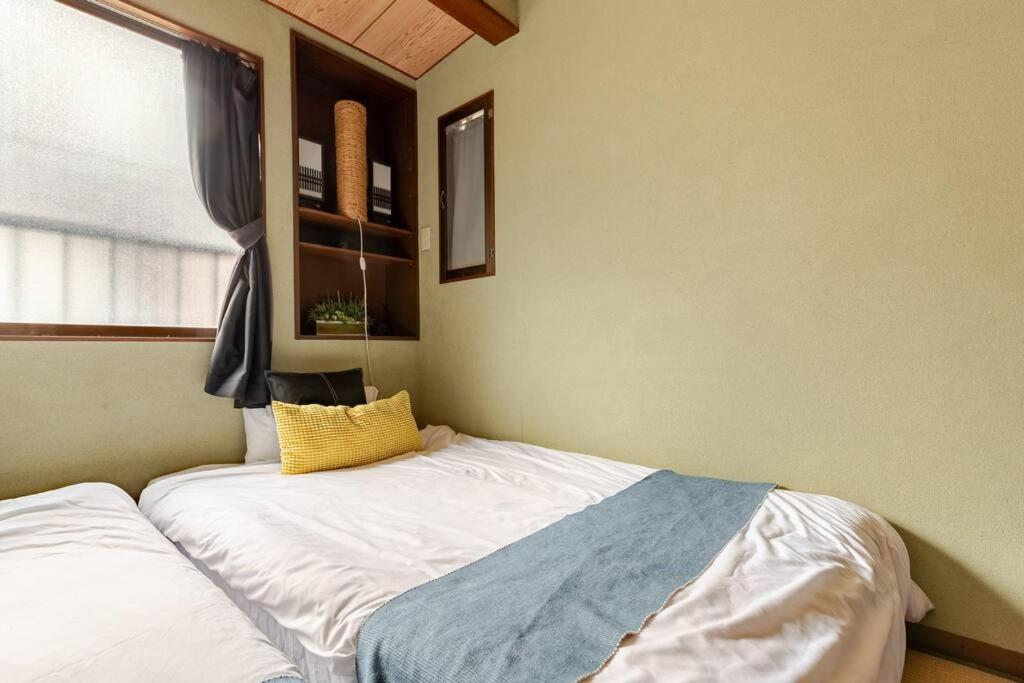 Cama ou camas em um quarto em Momodani 72 two-story detached house