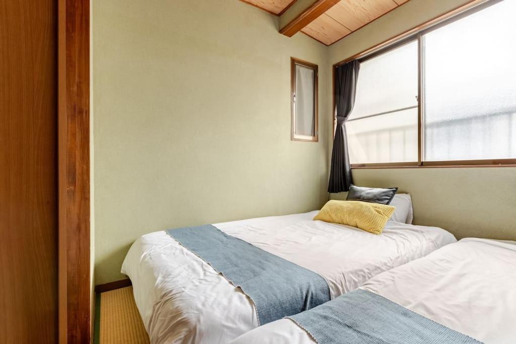 Cama ou camas em um quarto em Momodani 72 two-story detached house
