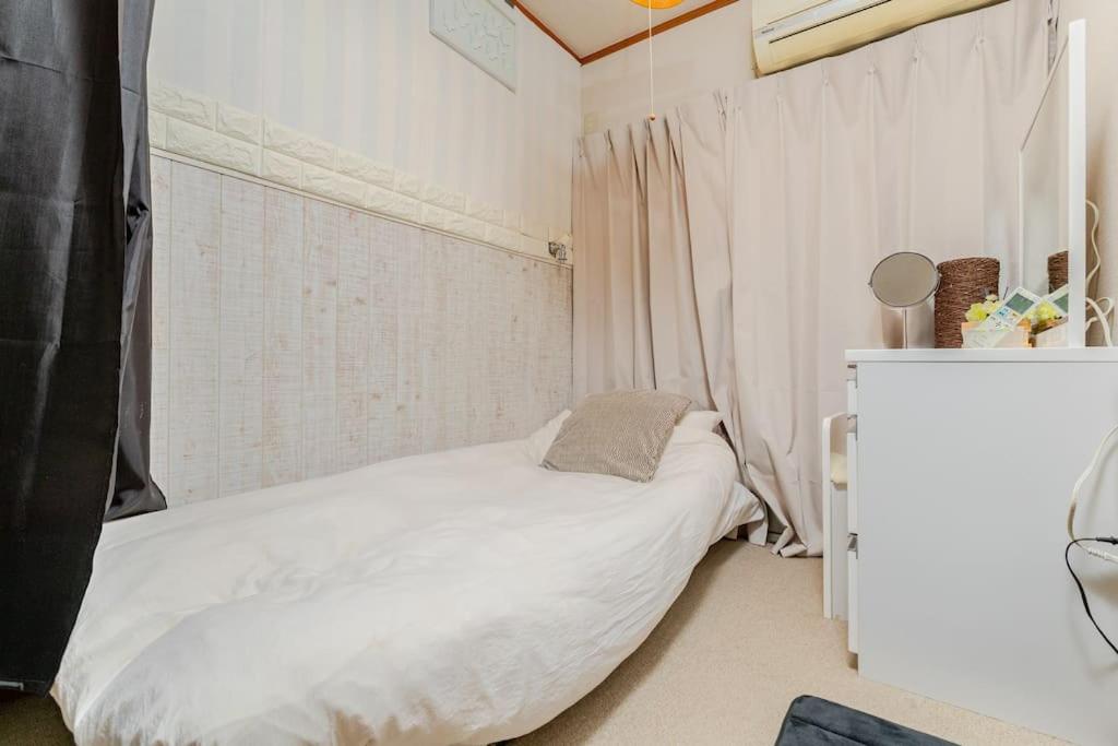 Cama ou camas em um quarto em Momodani 72 two-story detached house