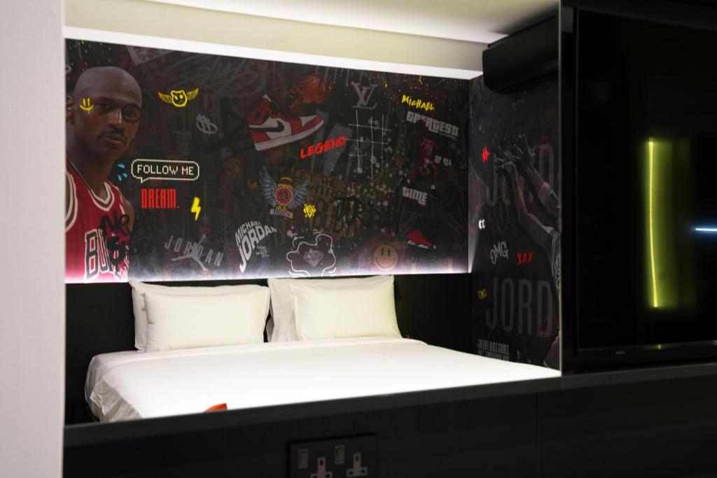 a bedroom with a bed with graffiti on the wall at SO City Hotel Adults Only in St. Julianʼs