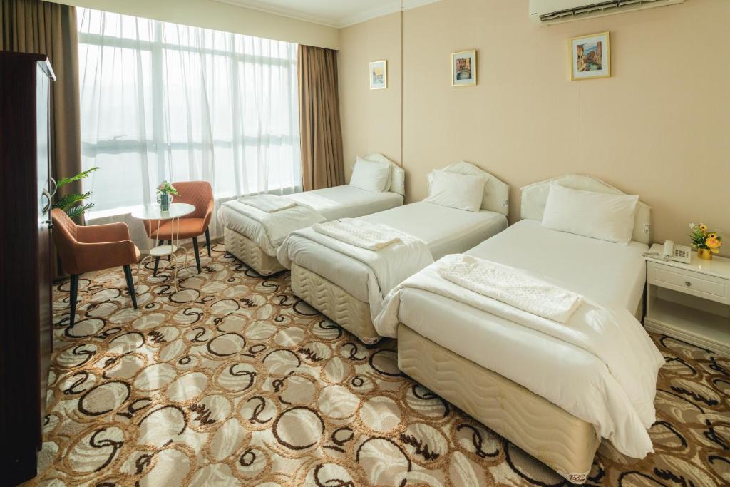 Voodi või voodid majutusasutuse Sur Inn Hotel Apartments صور ان للشقق الفندقية toas
