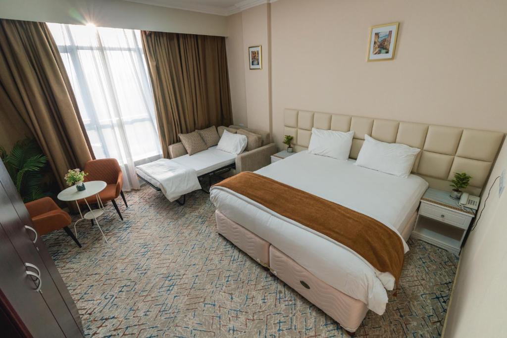 Voodi või voodid majutusasutuse Sur Inn Hotel Apartments صور ان للشقق الفندقية toas