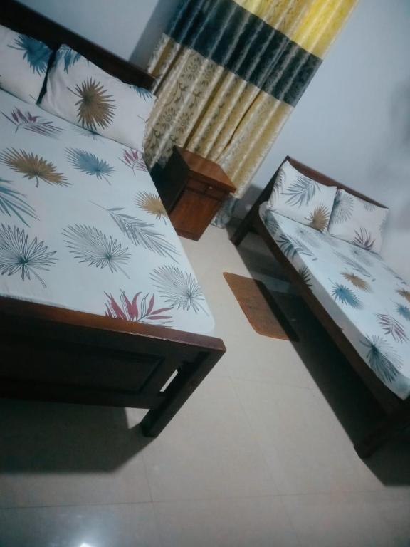 Postel nebo postele na pokoji v ubytování Chathuni Holiday Home