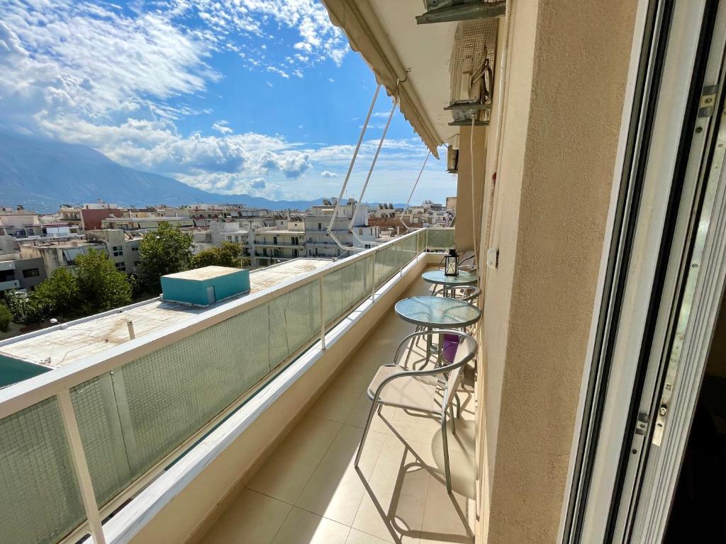 a balcony with chairs and a view of a city at Kalamata.House - Sunny and modern apartment with view! in Kalamata