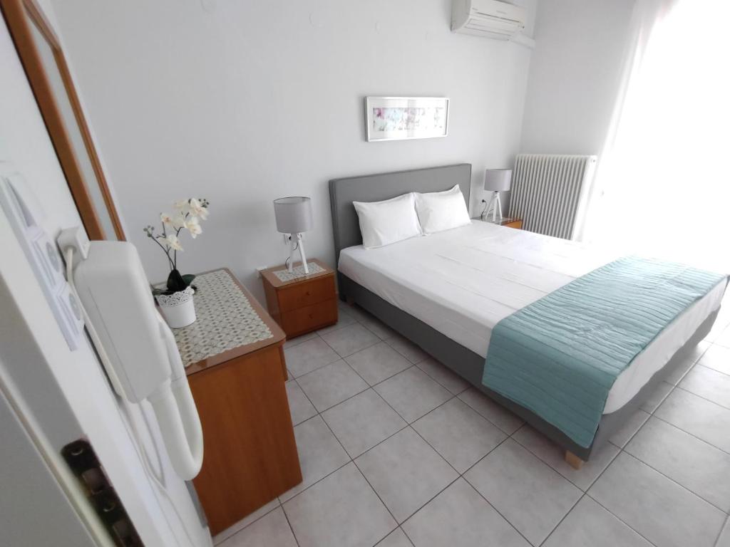 Postel nebo postele na pokoji v ubytování Ioli Apartments