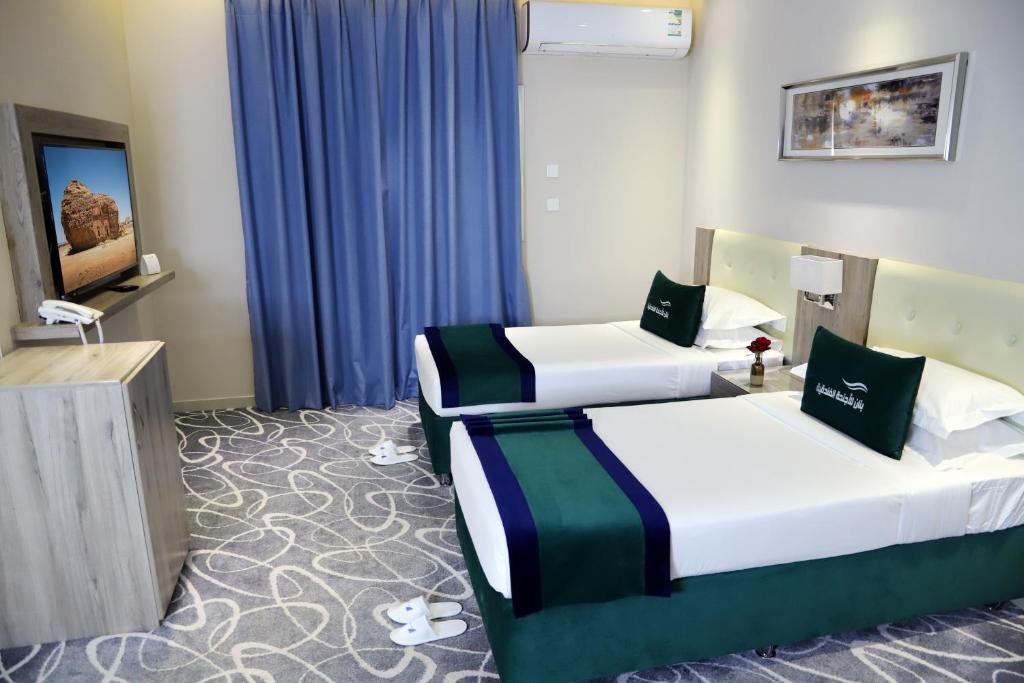 Postel nebo postele na pokoji v ubytování Sunrise Suites