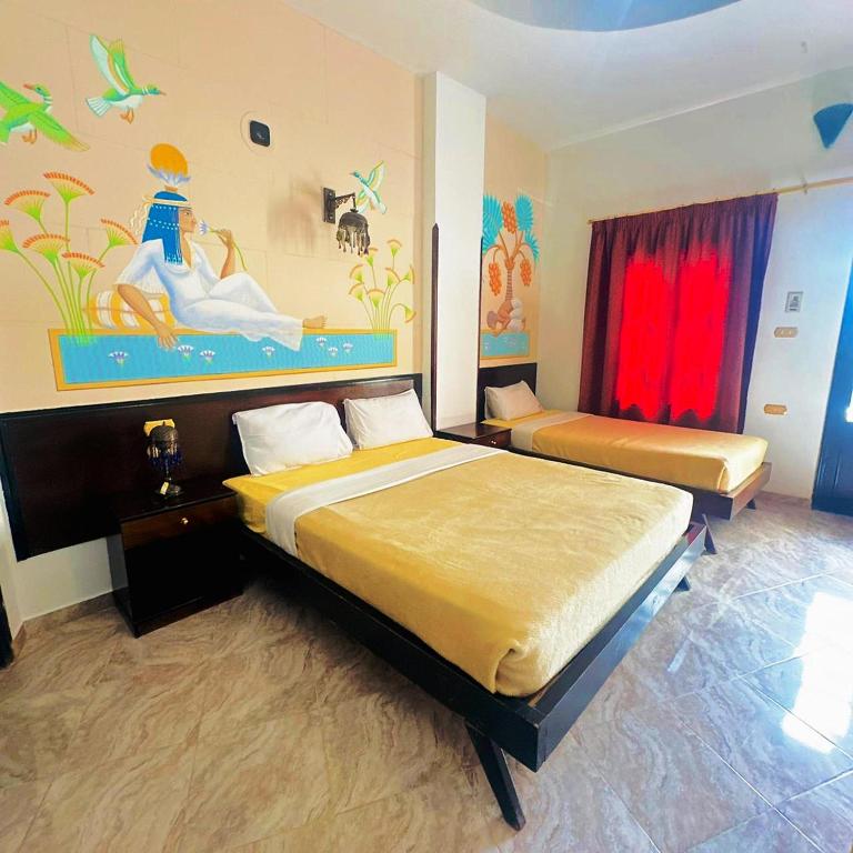 Postel nebo postele na pokoji v ubytování El Nakhil Hotel
