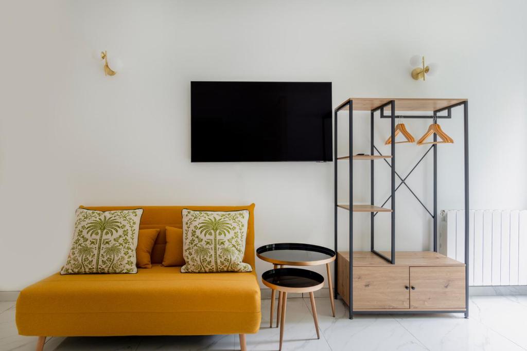 un salon avec un canapé jaune et une table dans l'établissement Modern apartment next Arc de Triomphe, à Paris