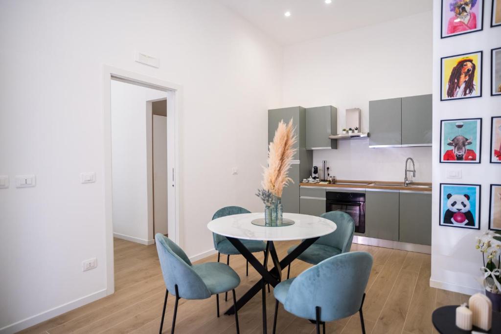 a kitchen and dining room with a table and chairs at Euphemia Glamour Apartment in Reggio Calabria