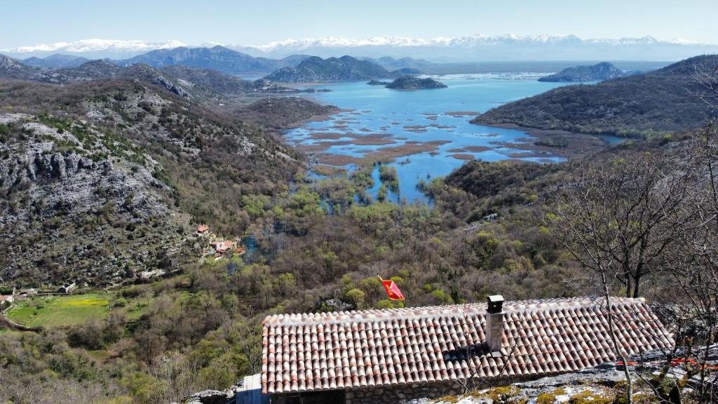 a view of a valley with a river and mountains at Panorama Stone Houses - Skadar Lake in Cetinje
