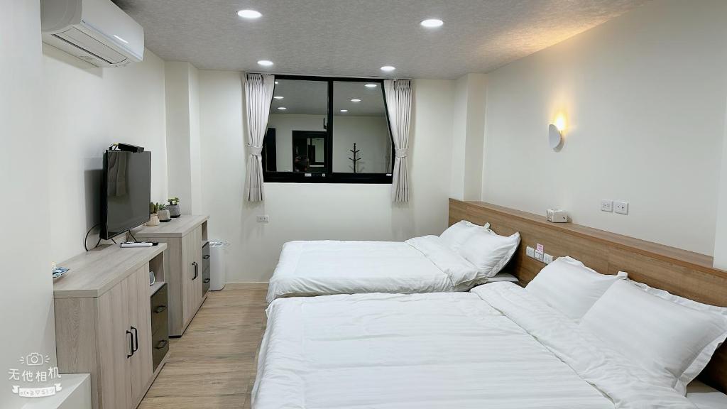 Postel nebo postele na pokoji v ubytování Fulong City B&B