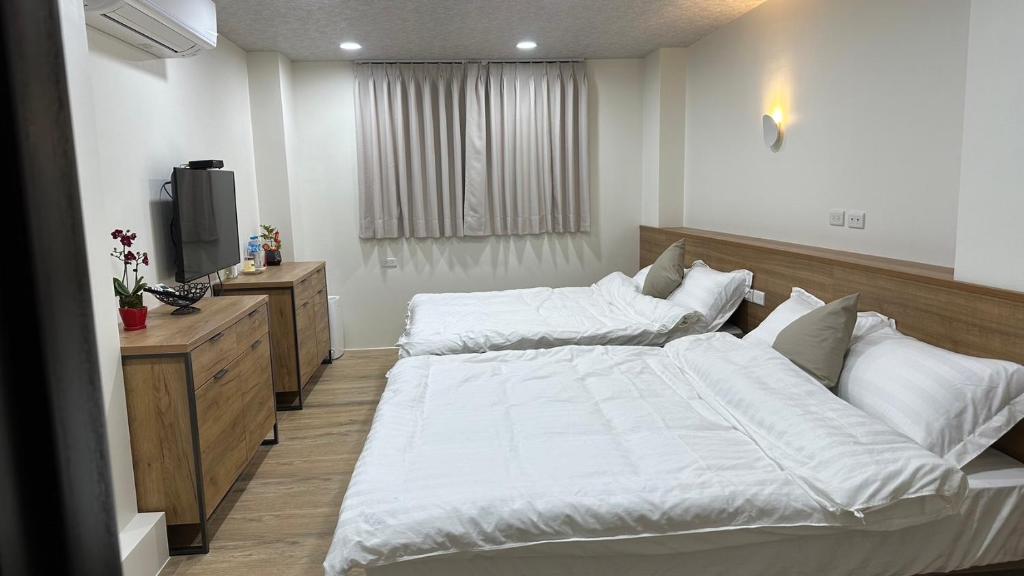 Postel nebo postele na pokoji v ubytování Fulong City B&B