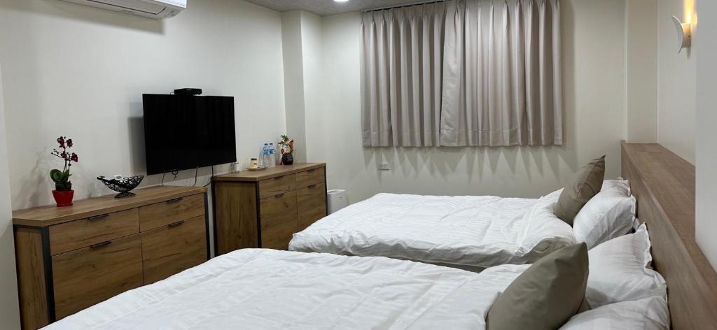 Postel nebo postele na pokoji v ubytování Fulong City B&B