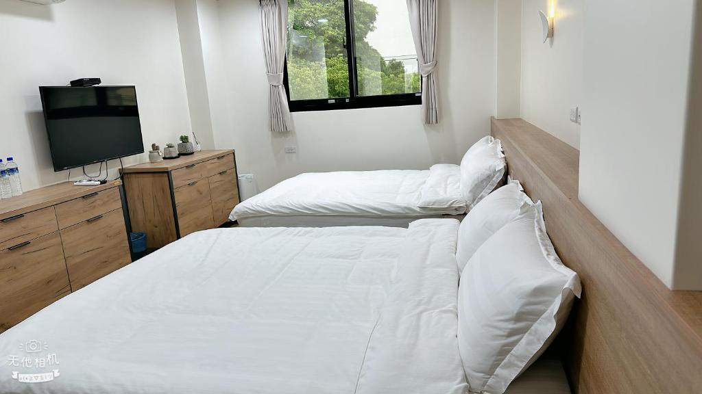 Postel nebo postele na pokoji v ubytování Fulong City B&B