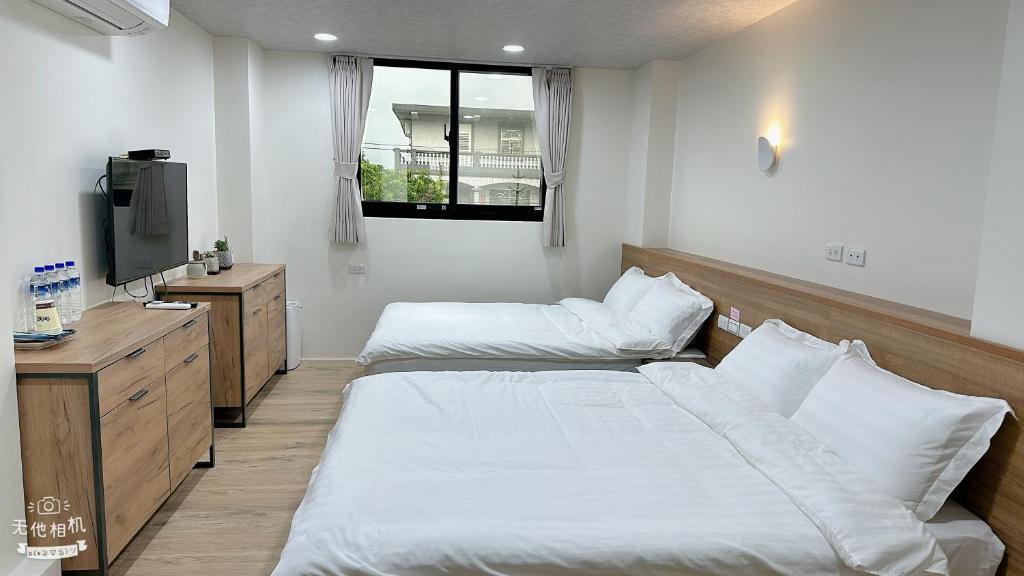 Postel nebo postele na pokoji v ubytování Fulong City B&B