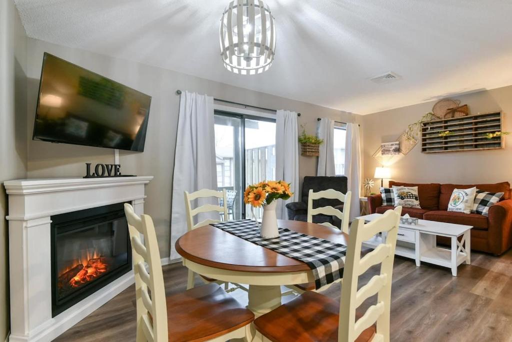 a living room with a table and a fireplace at Sweet Clover - Indoor pool - Hot Tub in Branson
