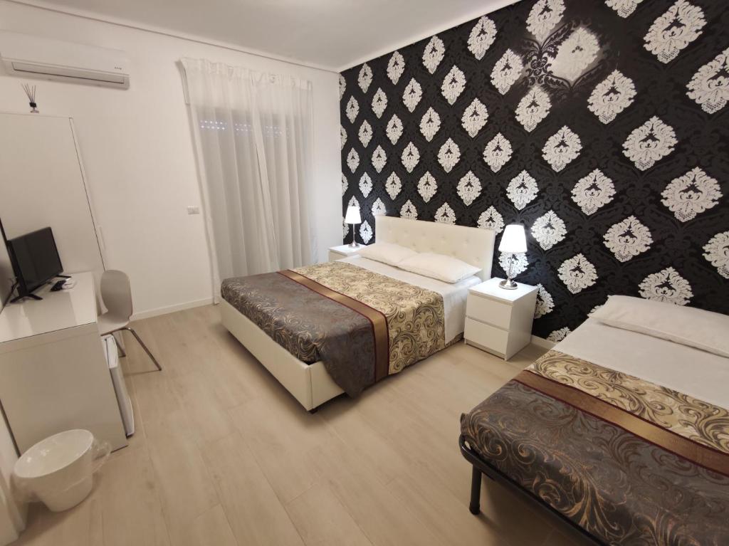Postel nebo postele na pokoji v ubytování SAMI Rooms Due - Teatro a 400 mt - Ortigia a 1500 mt -