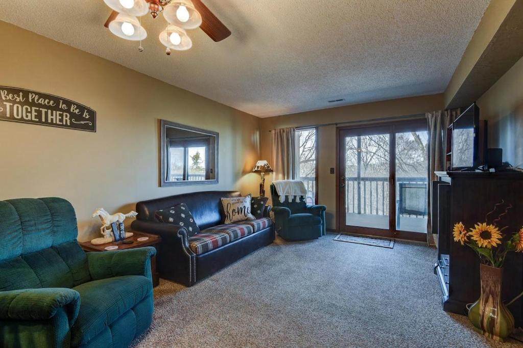 a living room with a couch and a table and a tv at Westcreek Ranch - No Stairs in Branson West