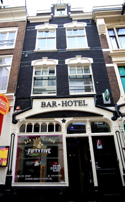 a bar building with a bar hotel on a street at Hotel 55 - City Centre in Amsterdam