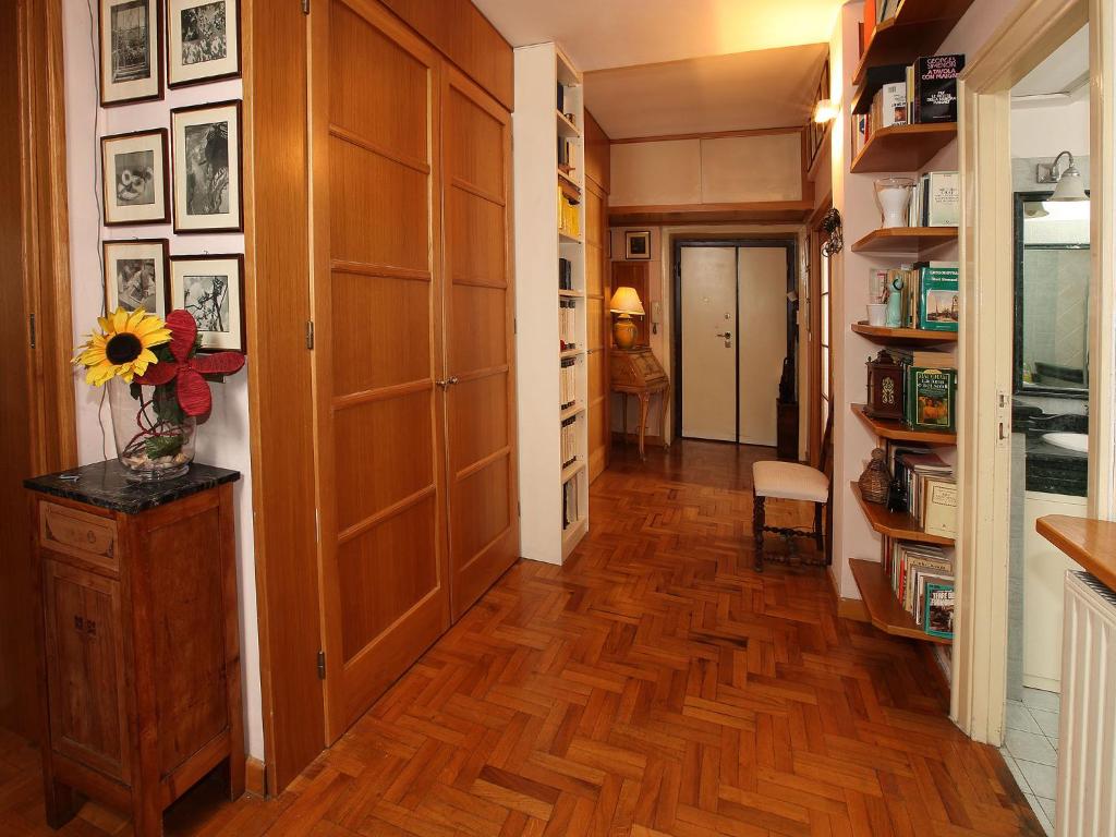 a hallway with a hard wood floor and a room with a door at Angelo Emo Home in Rome