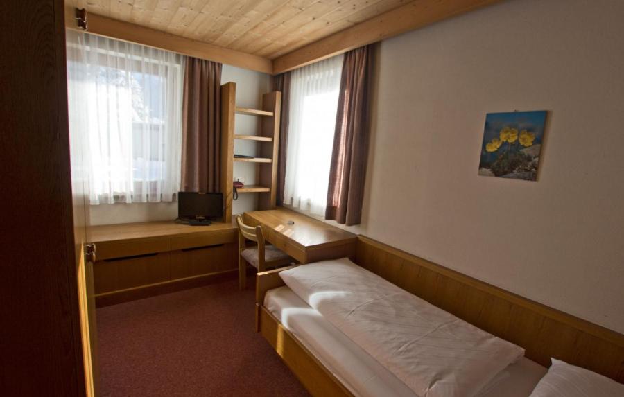 Postel nebo postele na pokoji v ubytování Hotel Vista Carnica