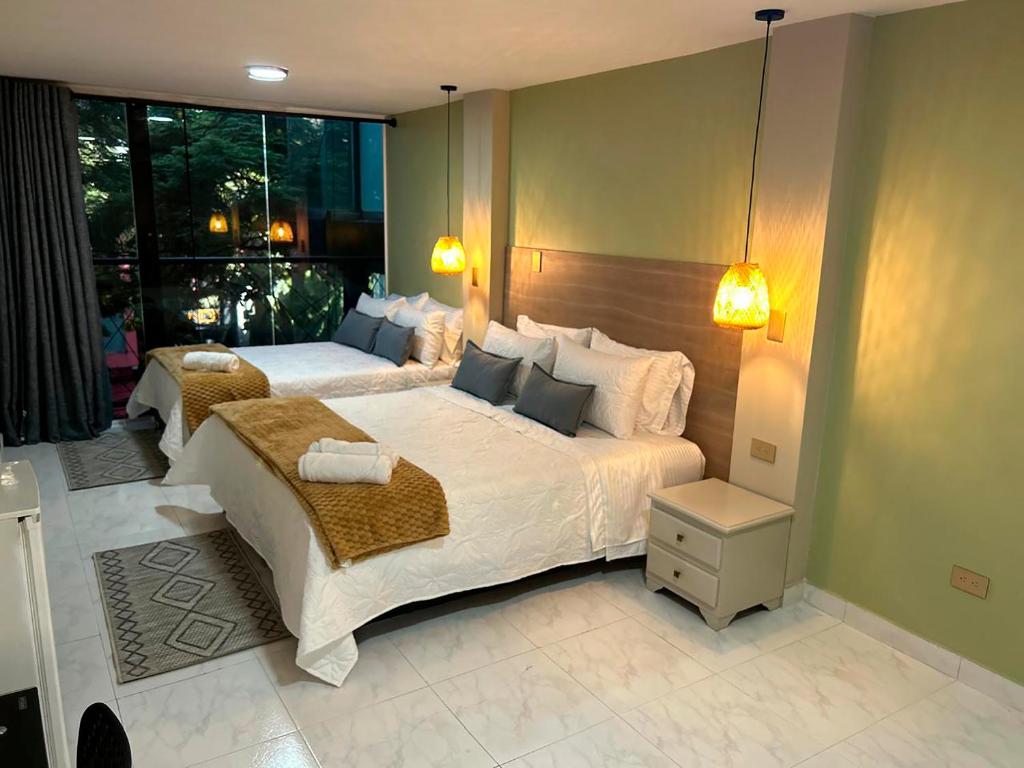 Postel nebo postele na pokoji v ubytování Provenza Medellin Hotel Boutique