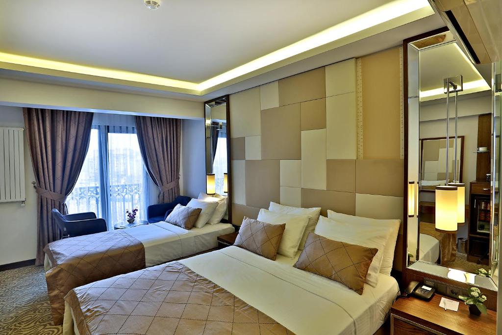 Postel nebo postele na pokoji v ubytování Grand Sagcanlar Hotel