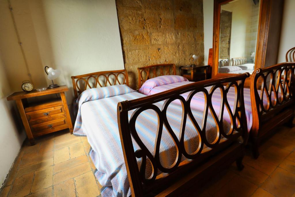 A bed or beds in a room at La Rocca - Palazzo Pallotti