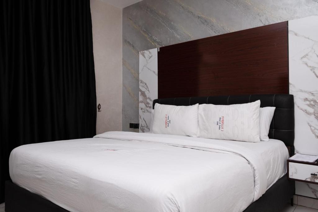 Postel nebo postele na pokoji v ubytování Formula 2 Hotels and Suites