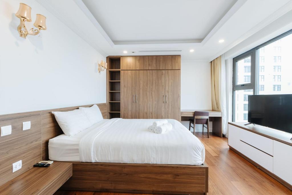 ハノイにあるD'Leroi Soleil - Modern Apartment by West Lakeのベッドと薄型テレビのある寝室
