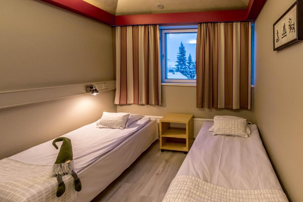 Vuode tai vuoteita majoituspaikassa Santa's Hotel Rudolf