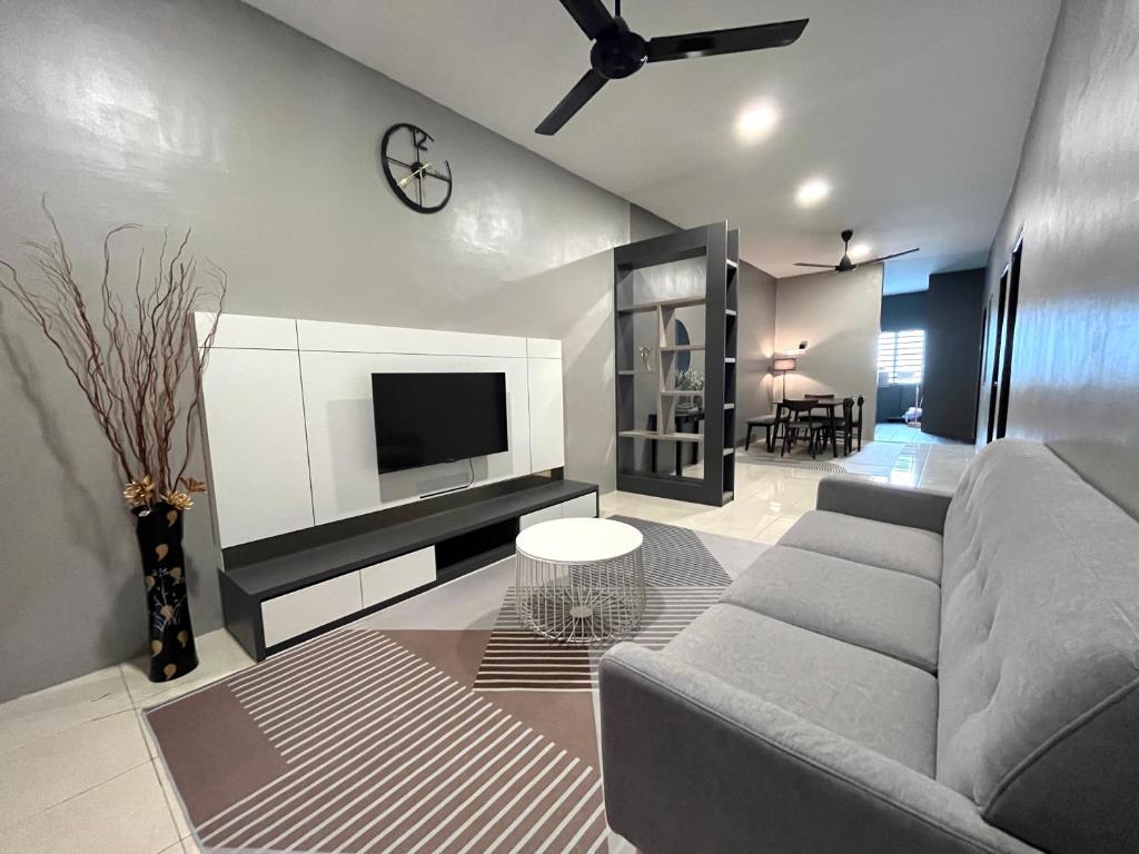 a living room with a couch and a tv at AbelHome in Teluk Intan