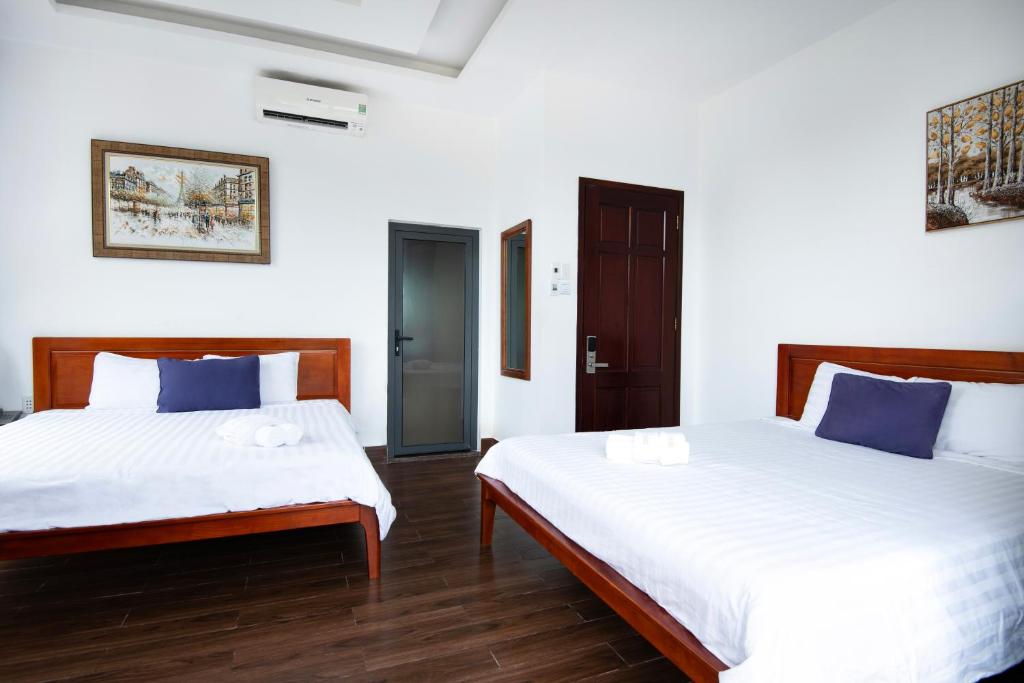 Postel nebo postele na pokoji v ubytování Kim Ngân II hotel