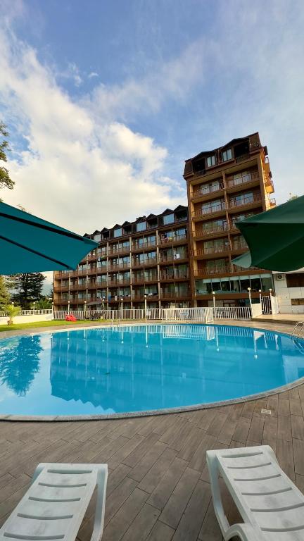 a large swimming pool in front of a hotel at Sputnik Hotel Batumi in Batumi