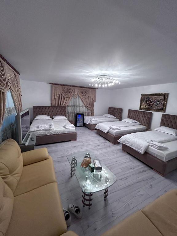 a living room with two beds and a coffee table at Villa Sara in Târgu Jiu
